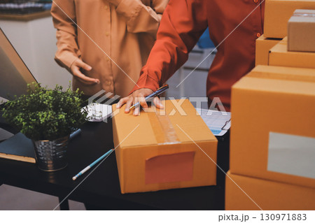 Portrait of Starting small businesses SME owners, two Asian woman check online orders Selling products working with boxs freelance work at home office, sme business online small medium enterprise 130971883