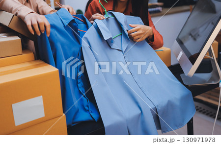 Portrait of Starting small businesses SME owners, two Asian woman check online orders Selling products working with boxs freelance work at home office, sme business online small medium enterprise 130971978