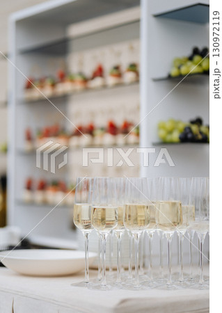 Elegant champagne glasses and canapes setup for stylish wedding or corporate event 130972119