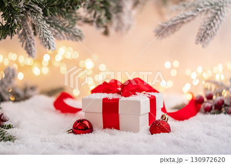 Christmas Gift and Ornaments on Snow with Tree Branches Christmas Gift and Ornaments on Snow with Tree Branches 130972620