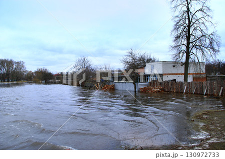 Flooding of river in spring in town during melting of snow. Natural disaster 130972733
