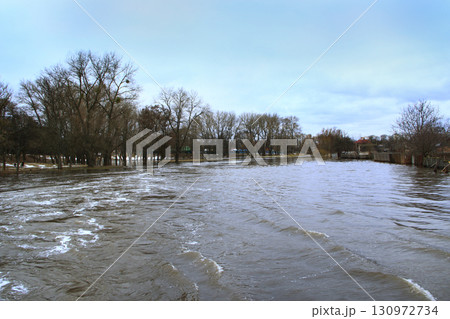Flooding of river in spring in town during melting of snow. Natural disaster 130972734