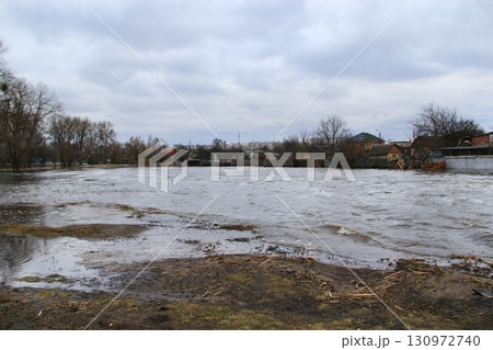 Flooding of river in spring in town during melting of snow. Natural disaster 130972740