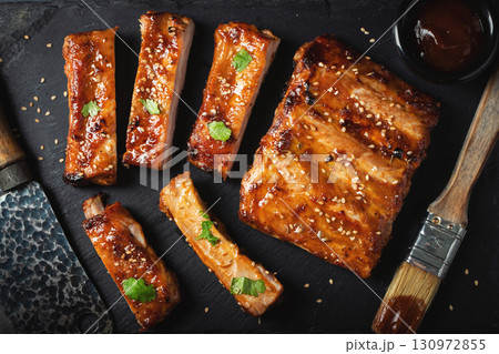 Barbecue pork spare ribs with hot honey chili marinade on black background Barbecue pork spare ribs with hot honey chili marinade on black background 130972855