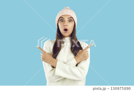 Surprised girl with crossed hands pointing with both index fingers Surprised girl with crossed hands pointing with both index fingers 130975890