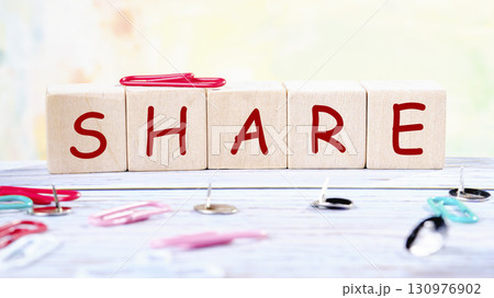The concept word SHARE is collected of wooden cubes on an abstract background. Technology, website concept The concept word SHARE is collected of wooden cubes on an abstract background. Technology, website concept 130976902