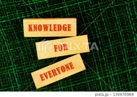 Education Concept text KNOWLEDGE FOR EVERYONE made of wooden blocks on fabric background, top view 130976969