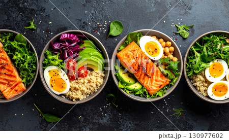 A colorful, healthy vegetarian dish of fresh vegetables on a wooden plate 130977602
