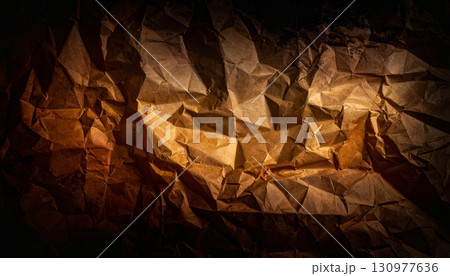 Dry autumn leaves on a crumpled brown paper background 130977636