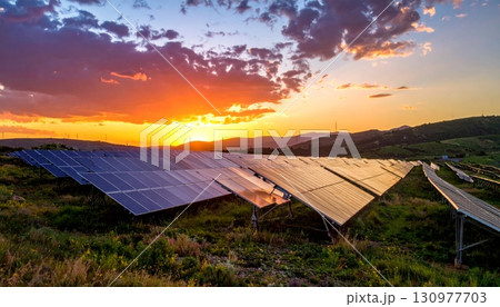 Vast photovoltaic panels on a green hillside generate clean solar energy under a clear blue sky, powering a sustainable future for a healthier environment Vast photovoltaic panels on a green hillside generate clean solar energy under a clear blue sky, powering a sustainable future for a healthier environment 130977703