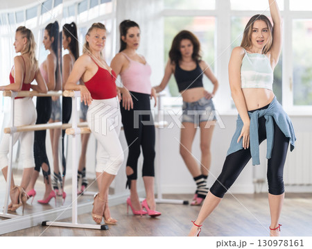 Young woman shows high heels dance to group Young woman shows high heels dance to group 130978161