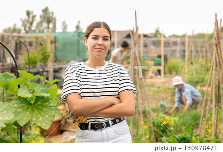 young girl in shorts at vegetable garden 130978471