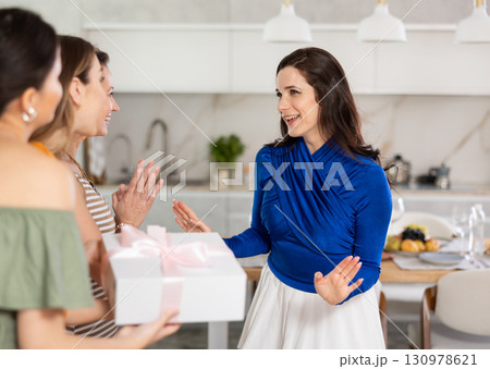 Cheerful girlfriends are happy to see each other at bachelorette party or party Cheerful girlfriends are happy to see each other at bachelorette party or party 130978621