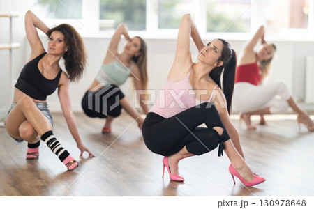 Group of women in high heels dances on floor 130978648