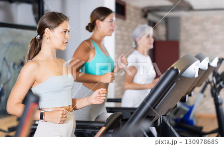 Young woman exercising on treadmill in gym 130978685
