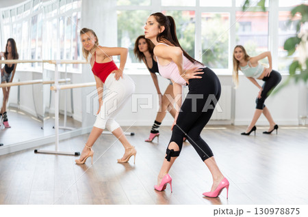Group of women dancing high heels in studio Group of women dancing high heels in studio 130978875