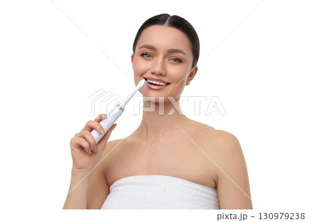 Smiling woman with electric toothbrush, isolated, PNG 130979238