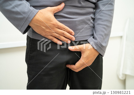 Hernia, Asian man stomach ache, abdominal pain and urology problem health. 130981221