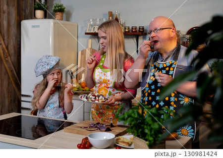 Enjoying Quality Time, Family Cooking Together in a Warm and Cozy Kitchen Setting Enjoying Quality Time, Family Cooking Together in a Warm and Cozy Kitchen Setting 130981424
