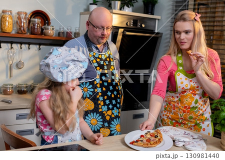 Engaging in Family Fun in the Kitchen Making Delicious Pizza Together as a Unit Engaging in Family Fun in the Kitchen Making Delicious Pizza Together as a Unit 130981440