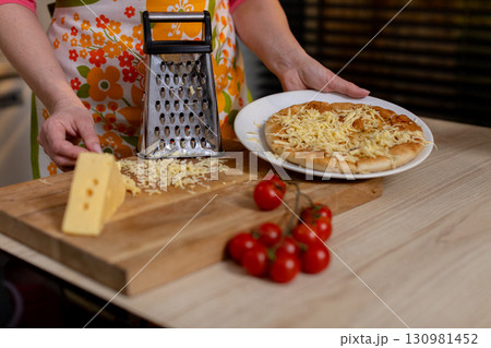 Delicious Homemade Cheese Pizza Preparation in a Cozy Kitchen for Ultimate Comfort Food 130981452