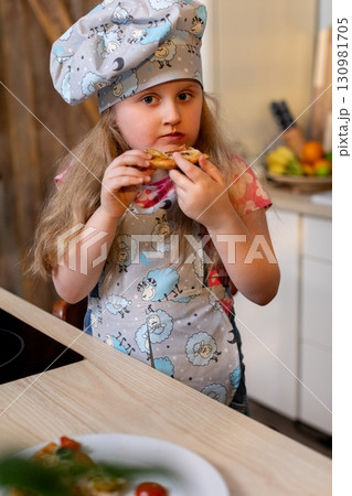 A Young Chef in the Kitchen, Joyfully Enjoying Delicious Homemade Treats and Snacks A Young Chef in the Kitchen, Joyfully Enjoying Delicious Homemade Treats and Snacks 130981705