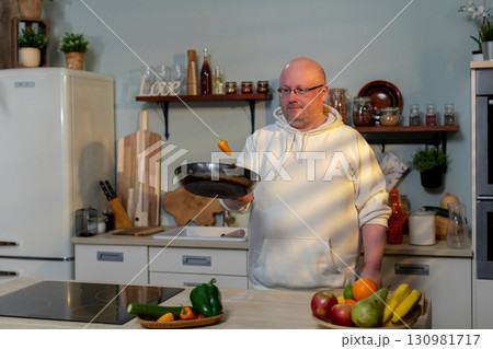 A talented chef is cooking in a modern kitchen using fresh and vibrant ingredients 130981717