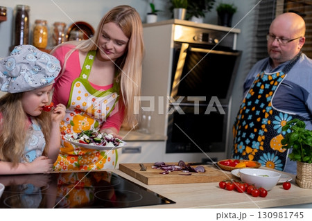 A Joyful Family Cooking Together in a Bright and Modern Kitchen Environment Full of Life A Joyful Family Cooking Together in a Bright and Modern Kitchen Environment Full of Life 130981745