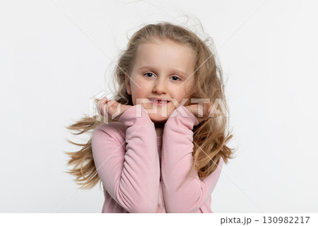 A Cheerful Happy Child Smiling Brightly While in a Playful and Joyful Pose, Radiating Happiness A Cheerful Happy Child Smiling Brightly While in a Playful and Joyful Pose, Radiating Happiness 130982217