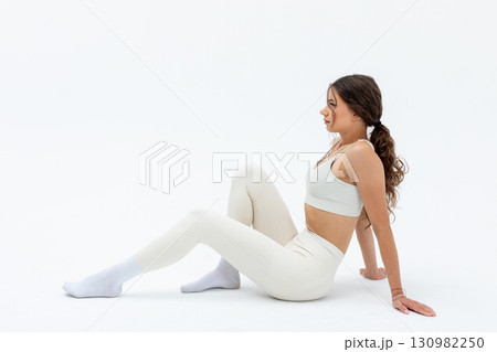 An Impressive Yoga Pose on a Bright White Background A Stylish Fitness Enthusiast An Impressive Yoga Pose on a Bright White Background A Stylish Fitness Enthusiast 130982250