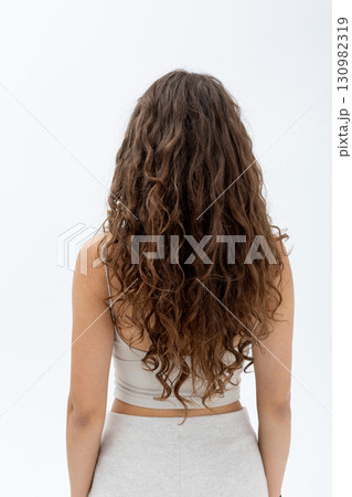 A Stunning Display of Beautiful Curly Hair Styled in a Fashionable Pose and Attitude 130982319