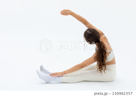 A Flexible Young Woman is Practicing Stretching in a Beautifully Minimalistic Setting Today A Flexible Young Woman is Practicing Stretching in a Beautifully Minimalistic Setting Today 130982357