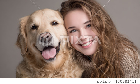 Young woman smiling happily with golden retriever dog closeup portrait 130982411