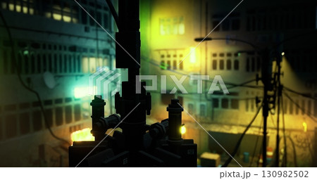 A vibrant urban setting showcases colorful lights reflecting off building facades at night. Cables and wires crisscross the view, creating an intricate visual atmosphere in the city. 130982502