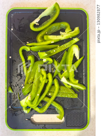 Sliced green bell peppers on a cutting board Sliced green bell peppers on a cutting board 130982877