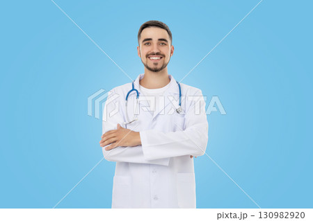Doctor wearing lab coat and stethoscope with arms crossed Doctor wearing lab coat and stethoscope with arms crossed 130982920