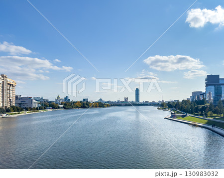 Cityscape with river and modern buildings on a sunny day 130983032