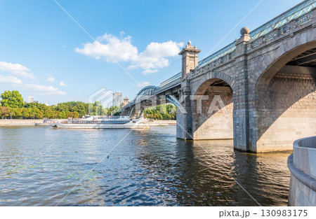 View of the Moscow river embankment, Pushkinsky bridge and cruise ships at sunset. 130983175