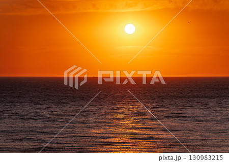 Beautiful red and orange sunrise over the sea. Beautiful red and orange sunrise over the sea. 130983215
