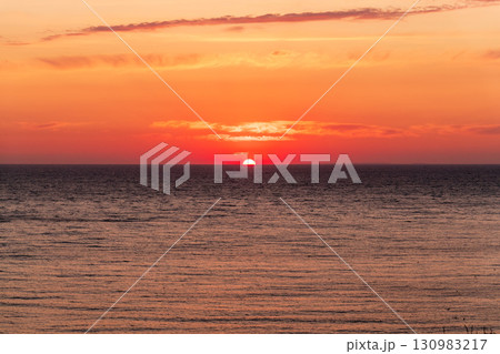 Beautiful red and orange sunrise over the sea. Beautiful red and orange sunrise over the sea. 130983217