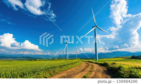 A wind farm with rows of turbines turning under a bright blue sky 130984200