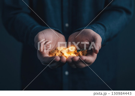 Closeup of hands distributing glowing coins into different sectors such as education and healthcare, funding distribution, government spending 130984443