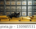 Gold bars in bank safe deposit box room with black cat close up 130985531