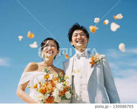 青空の下で微笑む幸せな新郎新婦 130986705