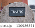Boost visibility, attract organic traffic, and dominate search engine concept. TRAFFIC written on the plaque of a large stone monument. 130986851