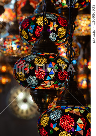 Lamps Mosaic Turkey Bazaar: Colorful handcrafted glass lamps hanging in a Turkish bazaar, showcasing intricate mosaic designs. 130986935