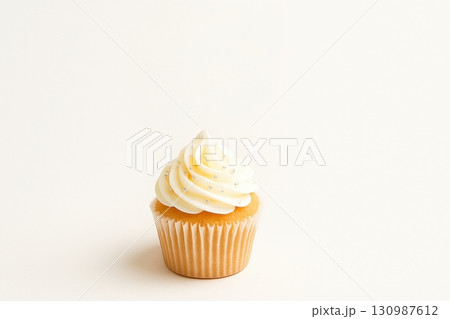 Vanilla cupcake with white frosting on plain background 130987612