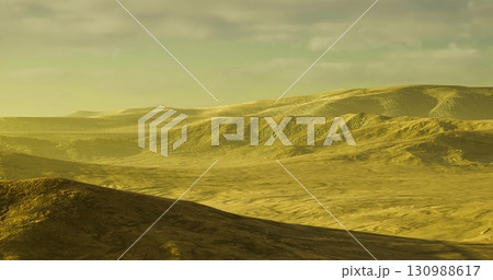 Expansive golden hills stretch across the horizon under a warm, hazy sky. The gentle slopes and valleys show the beauty of nature at dusk, inviting exploration and wonder. 130988617