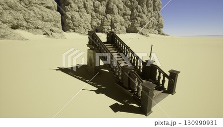 A wooden staircase stands alone in a vast sandy area, flanked by towering rocky cliffs on one side. The bright blue sky adds contrast, creating an otherworldly atmosphere. A wooden staircase stands alone in a vast sandy area, flanked by towering rocky cliffs on one side. The bright blue sky adds contrast, creating an otherworldly atmosphere. 130990931