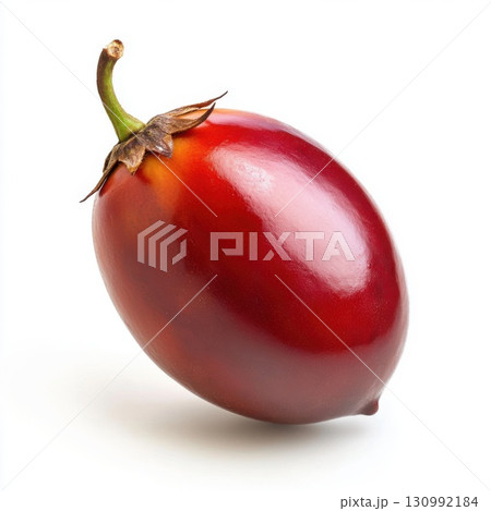 Fresh tamarillo fruit resting on a clean surface capturing its smooth texture and oval shape Fresh tamarillo fruit resting on a clean surface capturing its smooth texture and oval shape 130992184